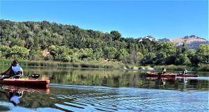 3 women kayaking on a lake