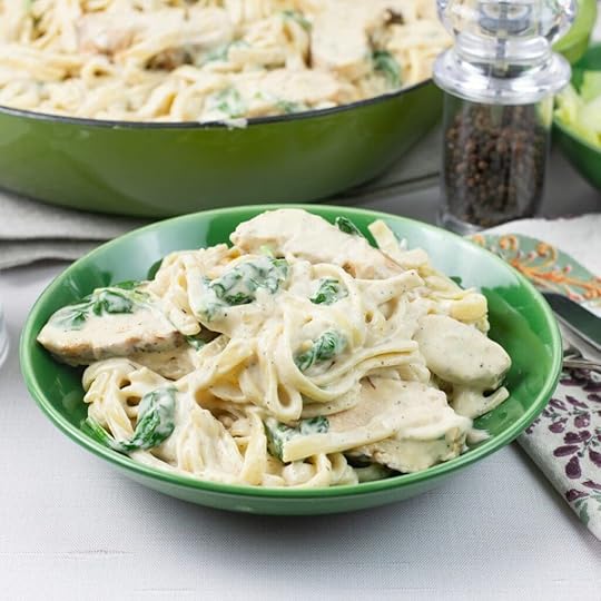 Chicken Spinach Alfredo served in a green bowl.