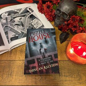 puzzle House book on a wooden backdrop. An open book of a picture of an Escher lithograph of staircases