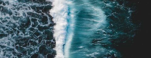 Aeriel photo of blue sea waves to illustrate the blog post 