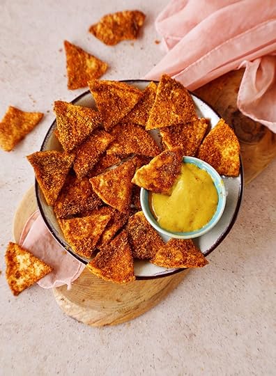 top shot of homemade doritos tortilla chips in bowl with cheese dip