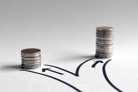 Image: On white paper is a simple drawing in permanent marker of a road forking into two paths. At the end of each path is a stack of coins, but one stack is twice as tall as the other.