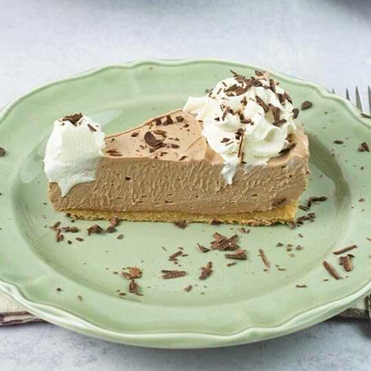 A slice of cheesecake made with Nutella cheesecake filling served on a dessert plate.
