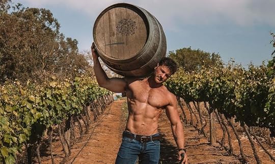 hot shirtless guy in vineyard carrying a wine barrel. 