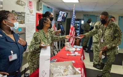 U.S. Navy sailors assigned to the aircraft carrier USS John C. Stennis distribute pamphlets to raise awareness for suicide prevention on the floating accommodation facility, in Newport News, Virginia, in 2021. Photo by Mass Communication Specialist 2nd Class Thomas Pittman, courtesy of the U.S. Navy.