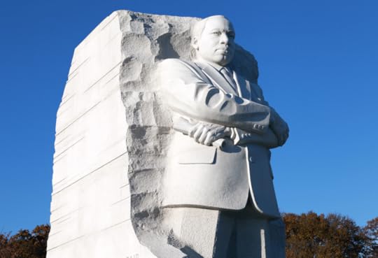The statue of Martin Luther King Jr. stands out against a bright blue sky