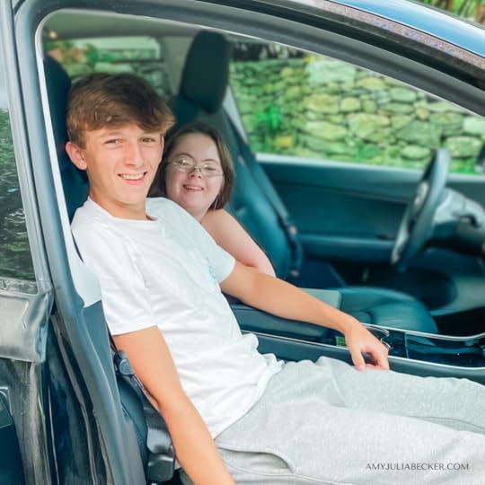 photo of William in the front seat of a car and Penny leaning forward from the back seat
