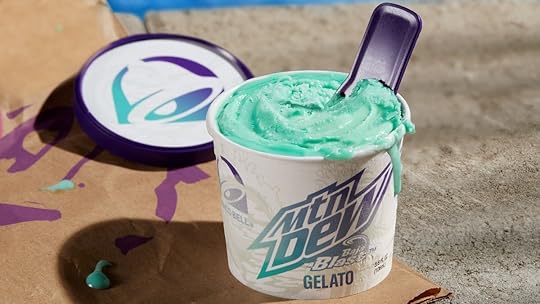 An open container of blue MTN DEW Baja Blast Gelato with a spoon from Taco Bell