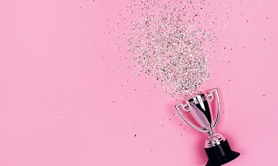bright pink background with silver glitter spilling out of a silver trophy, Writing Contests: What They Are and How to Write a Winning Submission
