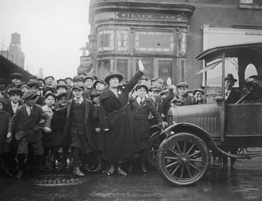 A women's equality day button with a red, white and blue background.