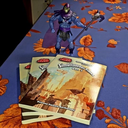 Skeletor poses with contributor copies of Simultaneous Times Volume 3.