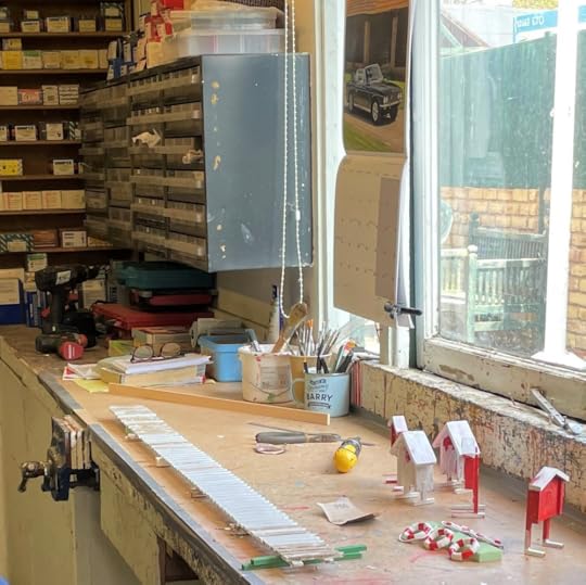 Model makers's workshop at Bekonscot Model Village: work bench hand tools, vice, drill, glasses and miniature life-saving rings being painted