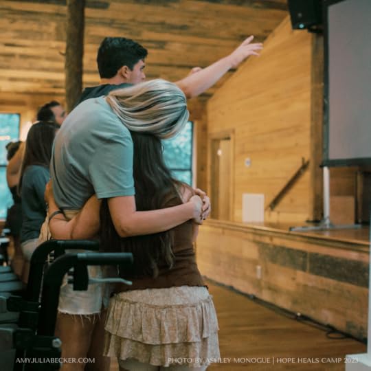 Penny and Katherine standing in a chapel and giving each other a hug