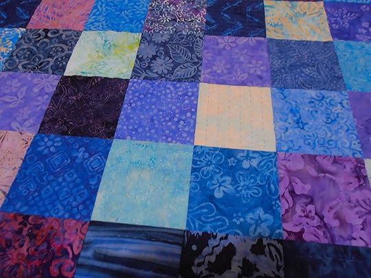 Multicoloured quilt with hand quilted stitches