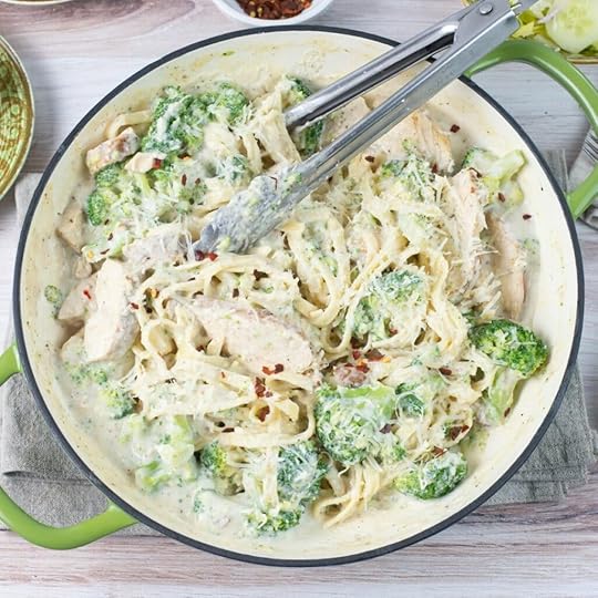 A large skillet full of Cajun Chicken Broccoli Alfredo.