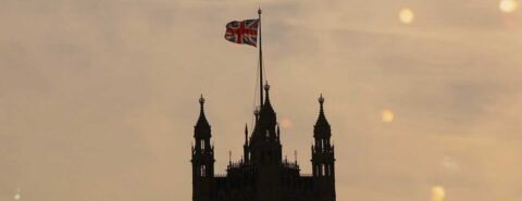 Union Jack flag flying atop a turret against a dusky sky to illustrate the blog post 