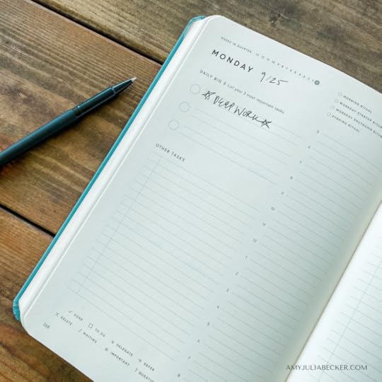photo of an open journal and a pen on a wooden table