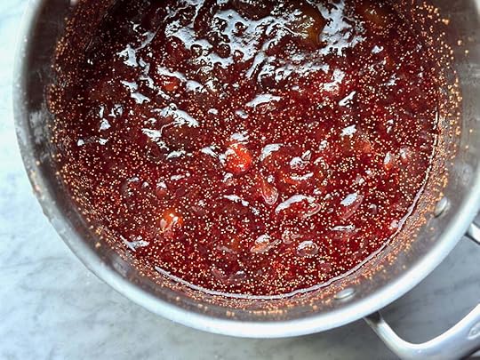 The finished fig jam, looking quite rosy, in a stainless steel pot.