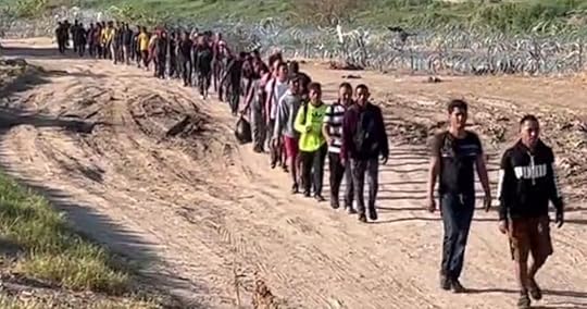 Young men who identified themselves as Venezuelans stream across the border near Eagle Pass, Texas.