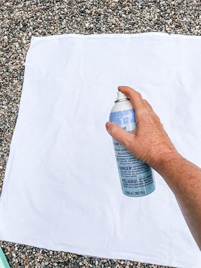 Spraying the spray adhesive onto the flannel
