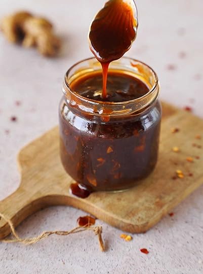 Korean bbq sauce in jar with spoon on wooden board