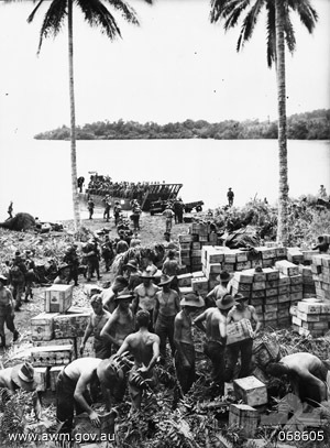 Australian transport company unloads supplies at Finschhafen, Oct. 1943 (Australian War Memorial: 068605)