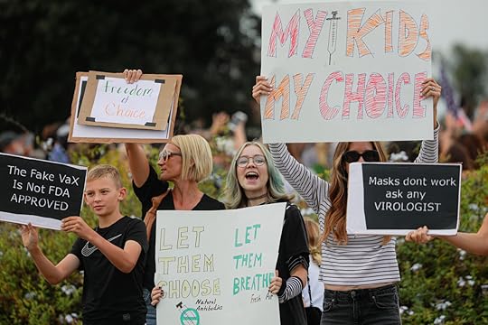 Anti-vaccine protesters stage a protest outside of the San Diego Unified School District office to protest a forced vaccination mandate for students.