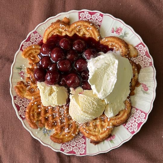 Ein Teller mit Waffeln, Eis, Sahne, Puderzucker