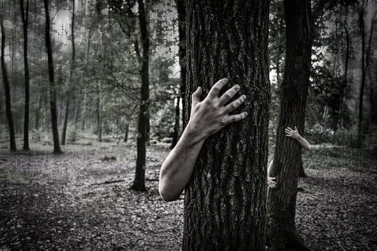 black and white photo of hands gripping tree trunks
