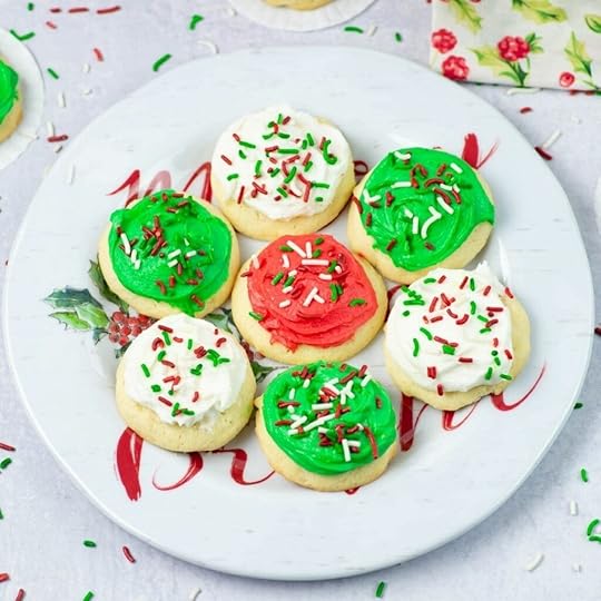 soft frosted Christmas cookies on a holiday plate.