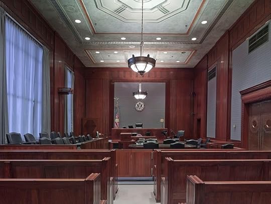 Empy courtoom with large windwos and wood paneling