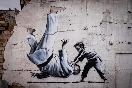 A mural shows a man being flipped during a martial arts match with a young boy. 