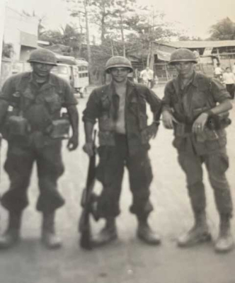 Jerry Lyons, right, on patrol in a village in Vietnam. Photo courtesy of the author.