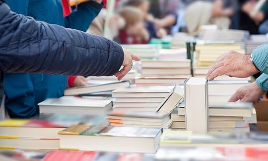 new books stacked on a table for sale, how to promote your self-published book