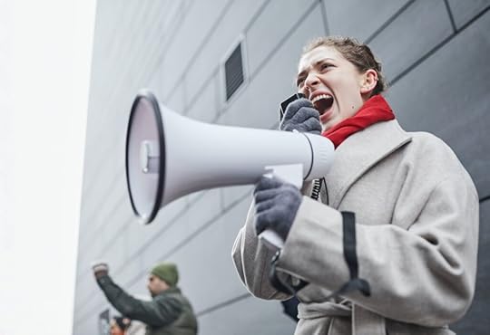 A woman holding a white megaphone.