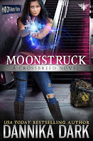 Blackhaired woman with mismatched eyes thrusting her hands forward, a ball of energy swirling around them. Background is a train station with staircase in the background and a backpack near her feet with a raven printed on it.