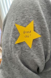 Gold star on an arm saying 