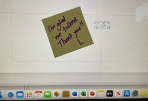 Post-it note stuck to a computer monitor that say, 