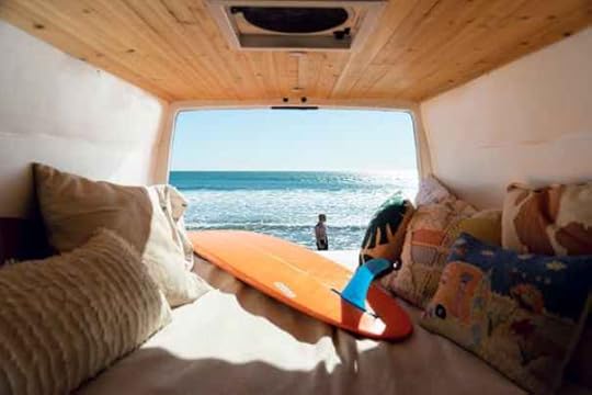 van-parked-at-beach-with-surfboard