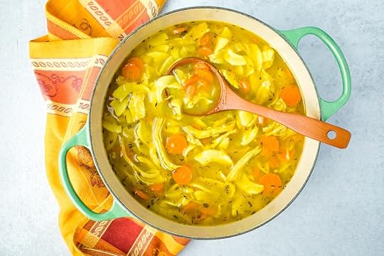 large pot of turmeric chicken soup with ladle in it ready to serve