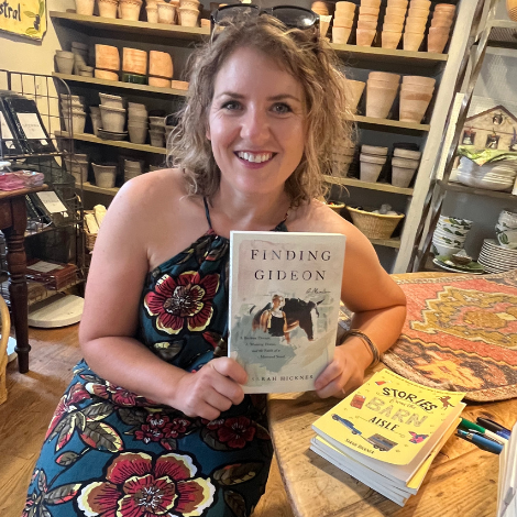 Sarah Hickner holds her book, Finding Gideon, in the store Creme de la Creme in Middleburg, Virginia