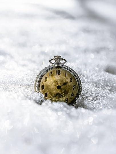 gold and black round pocket watch on snow