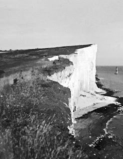Black and white photo of Beachy Head and its lighthouse,