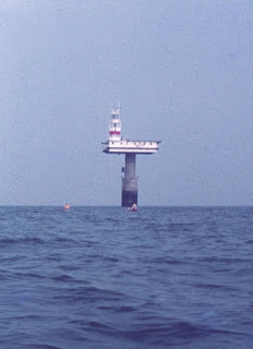 sea kayakers approach the Royal Sovereign lighthouse, Sussex, England