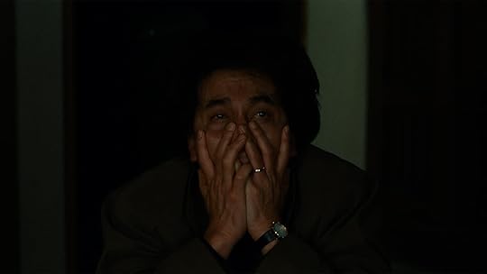 Kôji Yakusho covers his face in Kurosawa's