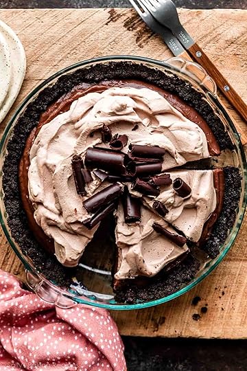 sliced chocolate pudding pie in Oreo cookie crust with mocha whipped cream on top.