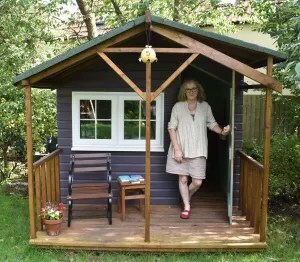 Debbie Young on the porch of her writing hut