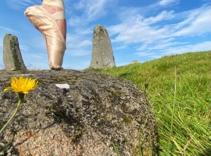 A celebratory dance in a stone circle. Ballet foot en pointe.