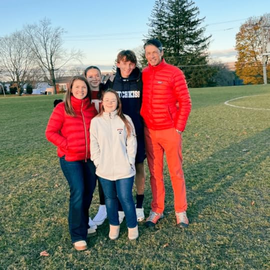 photo of the Becker family smiling at the camera outside after a soccer game. They are all wearing jackets or sweatshirts