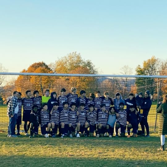 photo of William's soccer team posing in front of a soccer goal